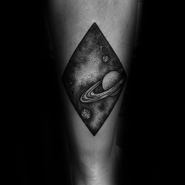 Black ink Saturn tattoo design for men inside a diamond shape, featuring dotwork stars and orbiting planets in a cosmic scene.
