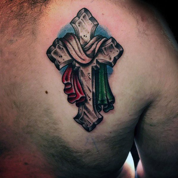 Stone cross tattoo on the upper back with the Italian flag draped over it, symbolizing faith, heritage, and cultural pride.