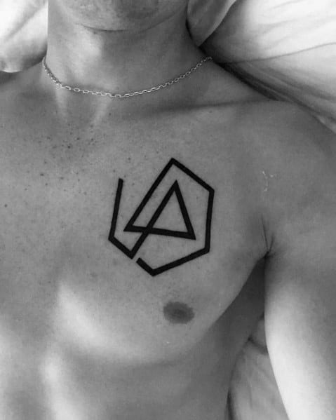 Bold black Linkin Park logo tattoo on the upper chest, featuring a clean and minimalist geometric design.