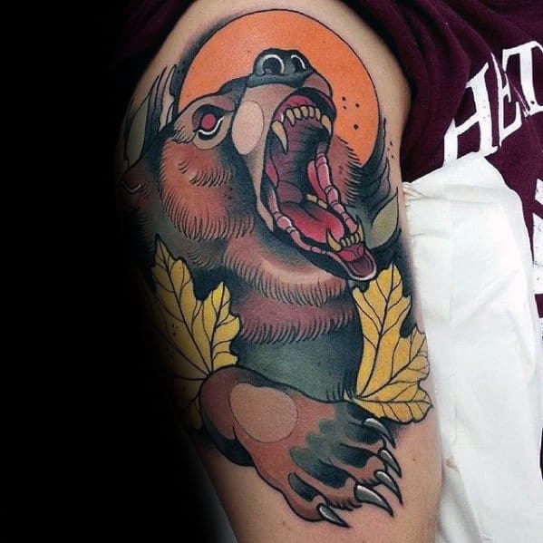 Neo-traditional bear tattoo on the arm featuring a roaring bear with autumn leaves, a bold orange sun, and dynamic shading for depth.
