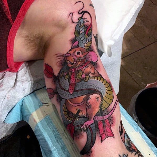 Neo-traditional tattoo of a rat in a tie wrapped by a coiled snake, with arrows piercing its body, blending bold outlines with rich shading.
