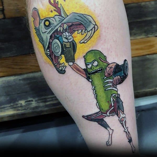 Pickle Rick tattoo in cyborg form, wielding a gun and fighting a monstrous rat, featuring bold colors and dynamic action on the leg.