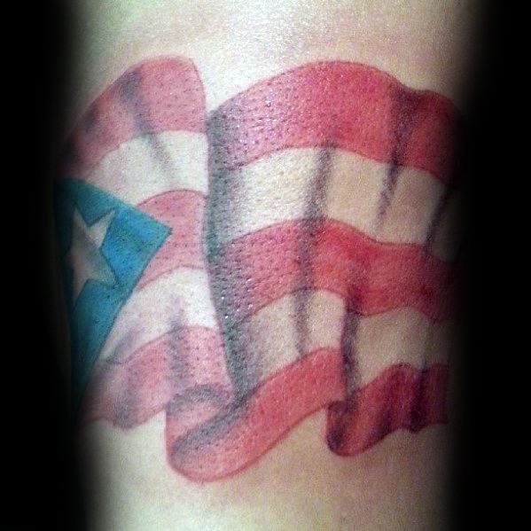 Puerto Rican flag tattoo with a realistic waving effect, featuring vibrant red, white, and blue colors with a bold star design.