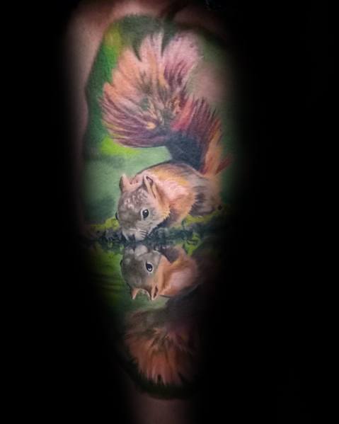 Tattoo of a squirrel with a perfect reflection in water, featuring vibrant colors and lifelike details for a striking nature-inspired design.