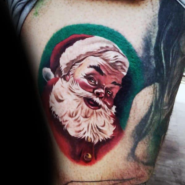 Realistic Santa Claus tattoo with a warm expression, detailed shading, and a festive green background, capturing a classic holiday look.