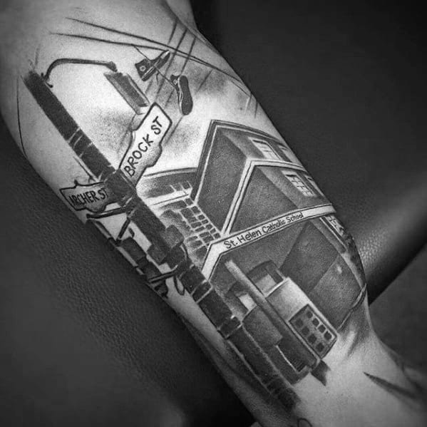 Black and grey tattoo of a detailed urban scene with street signs for Archer St and Brock St, power lines, a tram, and a building.