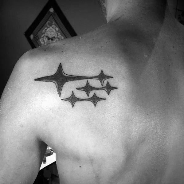 Black Subaru logo tattoo on the upper back, featuring the six-star emblem in a bold, clean design representing the brand’s identity.