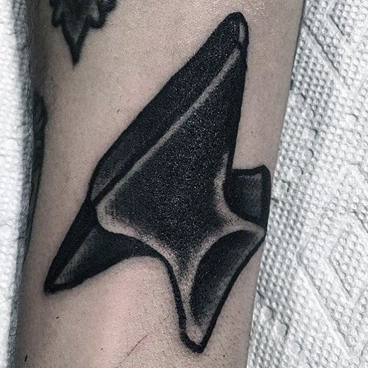 Black anvil tattoo with bold shading and high contrast, placed at an angle for a dynamic and striking appearance.