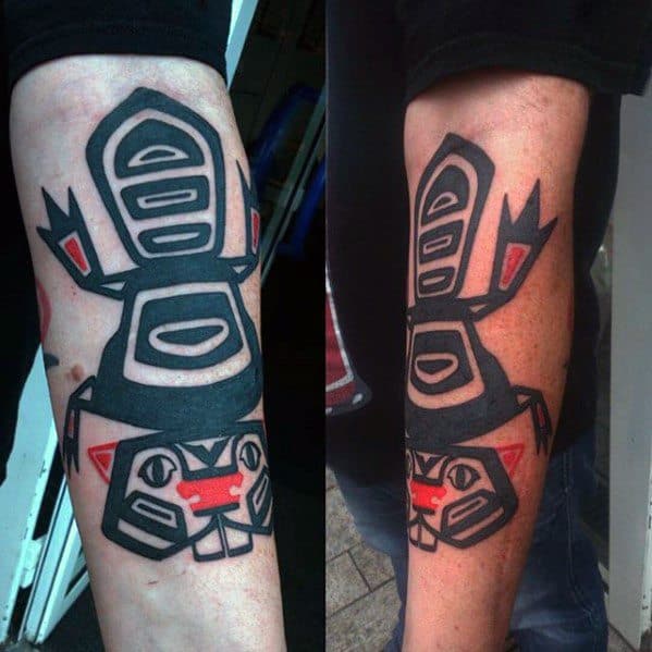 Forearm beaver tattoo in bold black and red Indigenous art style, featuring geometric shapes and strong symmetrical patterns.
