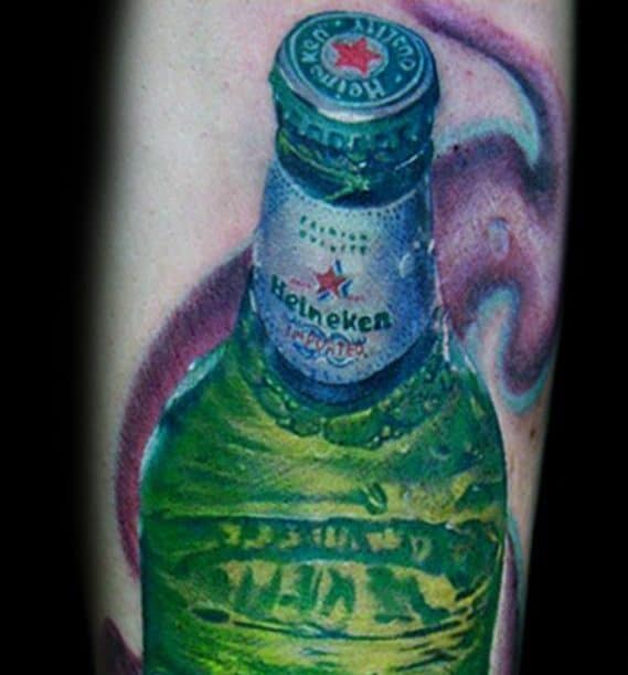 Hyper-realistic tattoo of a cold Heineken beer bottle with visible condensation and vivid green tones, set against a swirling purple background for contrast.