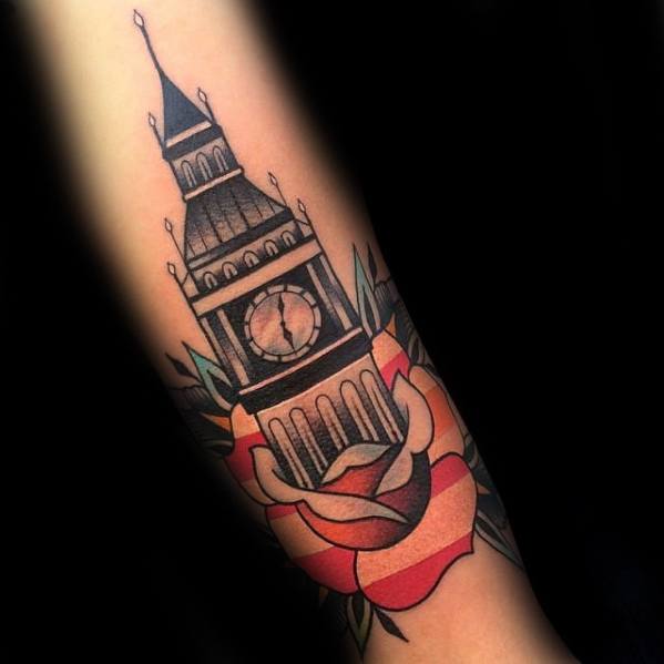 Detailed tattoo of Big Ben surrounded by a vibrant rose, with bold lines and colors, covering the forearm.