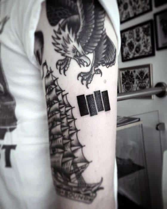 Classic Black Flag bars tattooed on the upper arm between a bold eagle and detailed ship, merging punk ethos with traditional designs.