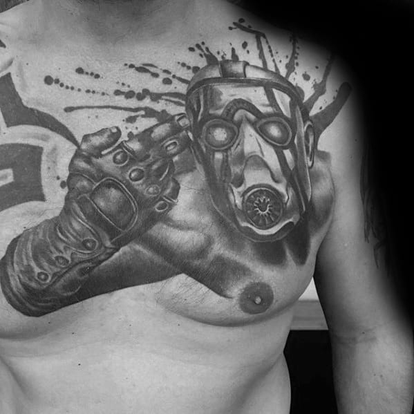 Realistic black and grey chest tattoo of a Psycho Bandit from Borderlands, featuring intense shading, finger gun pose, and splatter effects.