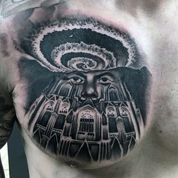 Chest tattoo of a gothic cathedral with a face emerging from its facade, topped by a swirling galaxy for a mystical, cosmic effect.