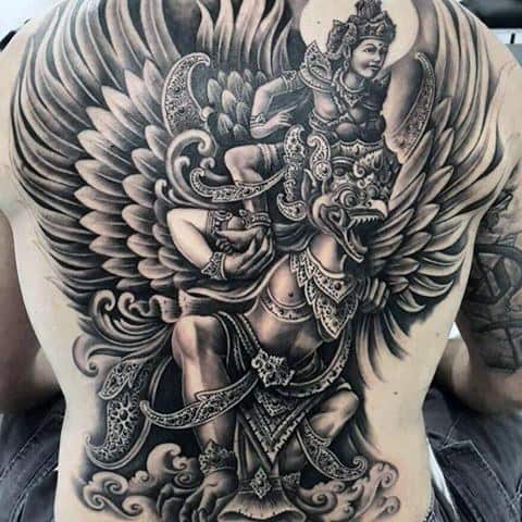 Full back Garuda tattoo in black and grey, featuring a powerful winged deity carrying a divine figure, surrounded by ornate detailing and clouds.