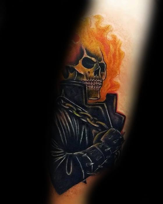 Stylized Ghost Rider tattoo with a flaming skull, spiked leather jacket, and bold chain in a clean, comic-inspired design.