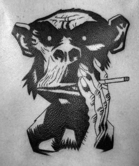 Bold blackwork tattoo of a stylized smoking gorilla, holding a cigarette with a skeletal hand, featuring sharp lines and high contrast.