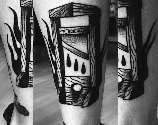 Heavy blackwork guillotine tattoo with bold shading, wood grain lines, three large blood drops, and surrounding flame-like patterns.
