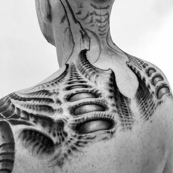 HR Giger-style biomechanical tattoo on the neck and shoulder, featuring spine-like ridges and alien textures blending with the skin.