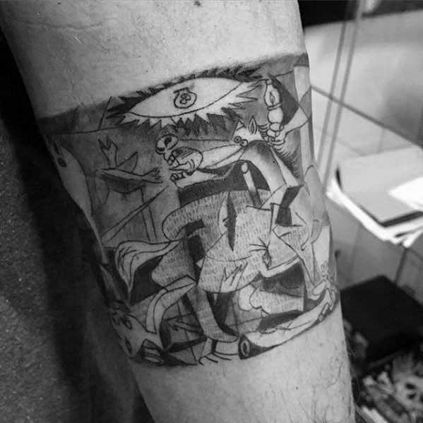 Upper arm tattoo of a detailed section from Picasso’s *Guernica*, showing fragmented figures and the iconic eye with a light bulb.