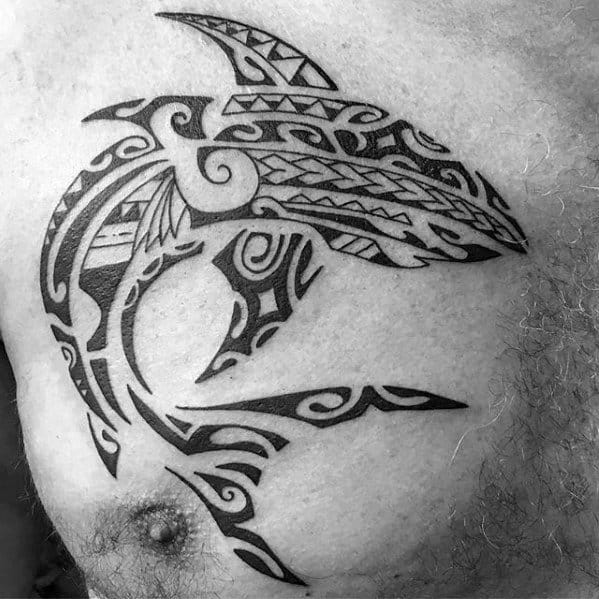 Polynesian shark tattoo on chest with flowing tribal patterns symbolizing protection, guidance, and connection to ancestral roots.
