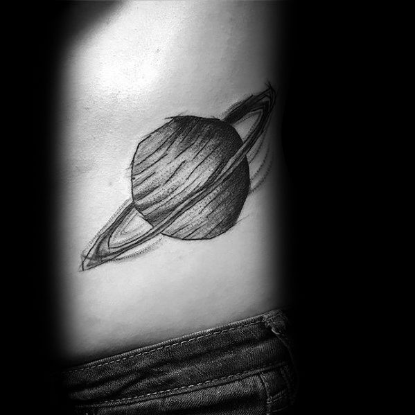 Simple black Saturn tattoo design for men with sketch-style shading and clean ring details placed on the side torso.