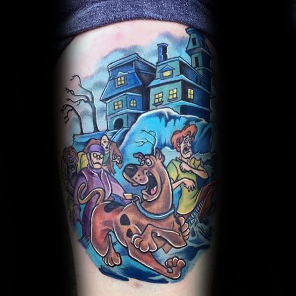 Tattoo of Scooby-Doo and the gang running from a haunted house at night, with a spooky blue glow and animated expressions.