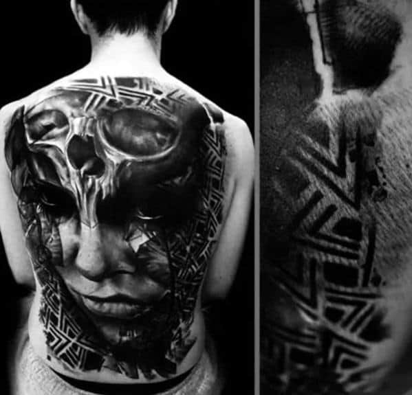 Abstract skull and face back tattoo merging realism and tribal patterns, creating a haunting, high-contrast visual fusion.