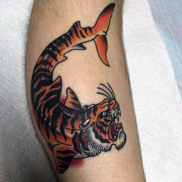 Bold tiger shark hybrid tattoo with a fierce tiger head and striped body, blending predator traits in a striking traditional style.