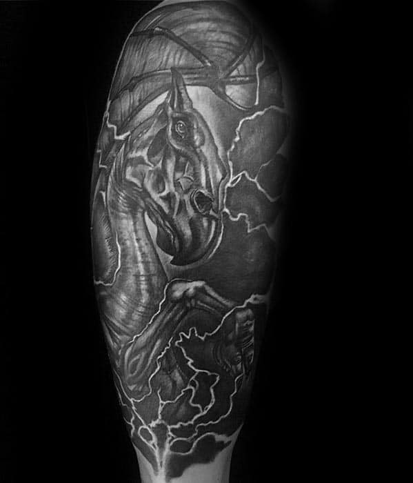 Bold Thestral tattoo in black and grey, featuring lightning effects and dynamic shading for a dramatic look on the lower leg.