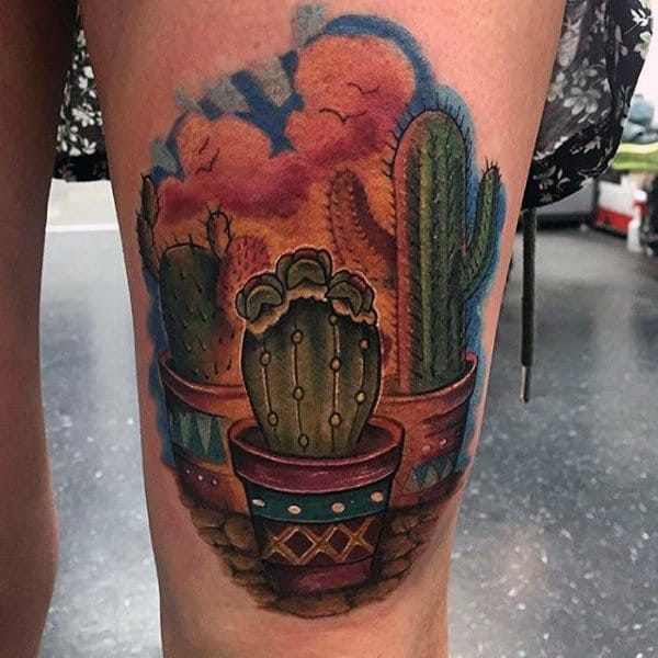 Guys Thigh Tattoo Of Cactus With Colorful Clouds