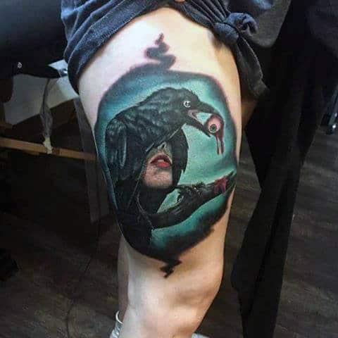 Guys Thighs Black Raven Holding Eye Ball Tattoo