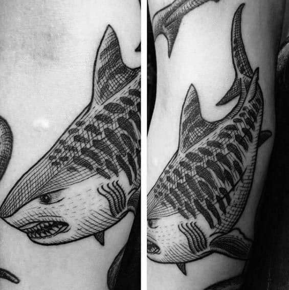 Detailed blackwork tiger shark tattoo featuring fine line shading and bold patterns, giving it a textured, hand-drawn appearance.
