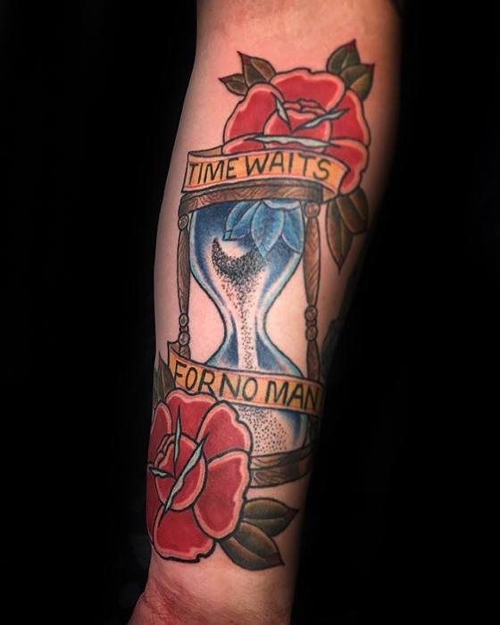 Traditional-style tattoo with an hourglass, blue sand, red roses, and a banner reading Time Waits for No Man.