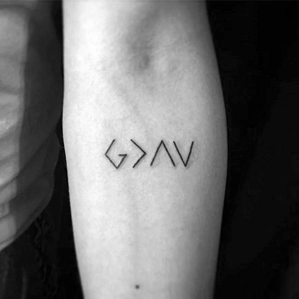 Forearm tattoo featuring the "God is greater than the highs and lows" symbol in minimalist black line style
