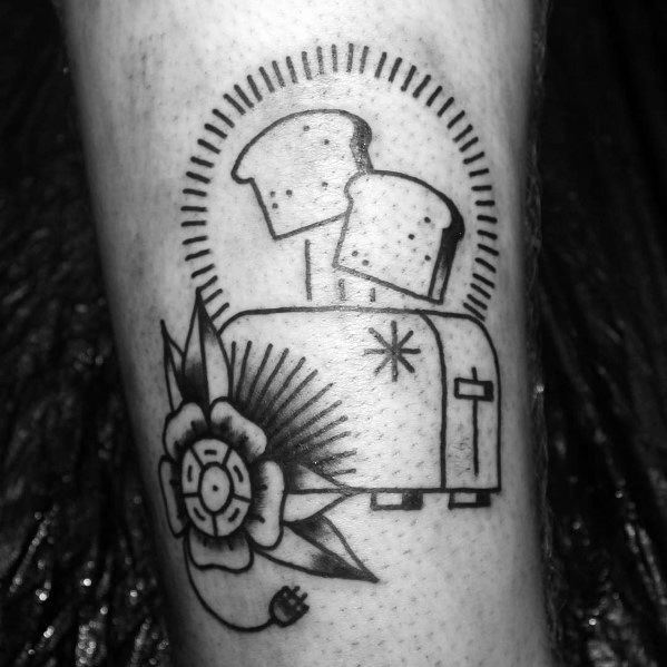 Bold blackwork toaster tattoo with two slices of bread popping up, surrounded by a decorative floral element and radiant lines for a vintage feel.