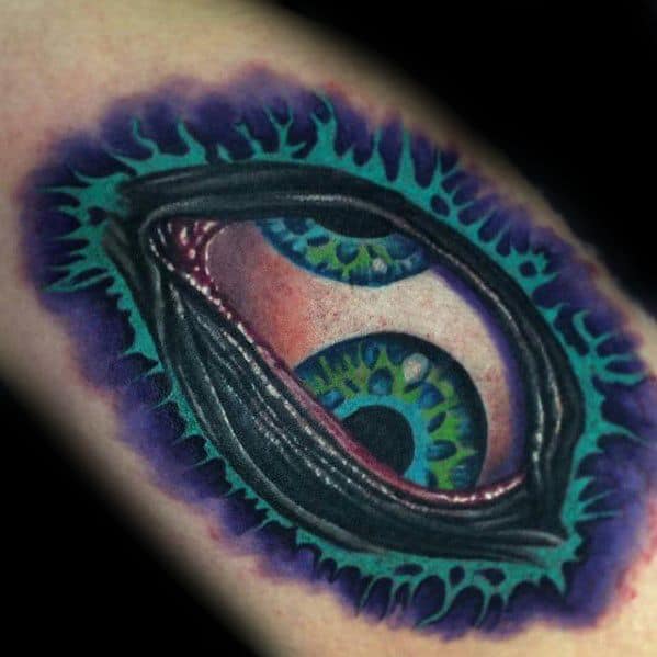 Vibrant Tool-inspired tattoo of two green-blue eyes peeking through a torn, teal and purple organic opening with surreal details.