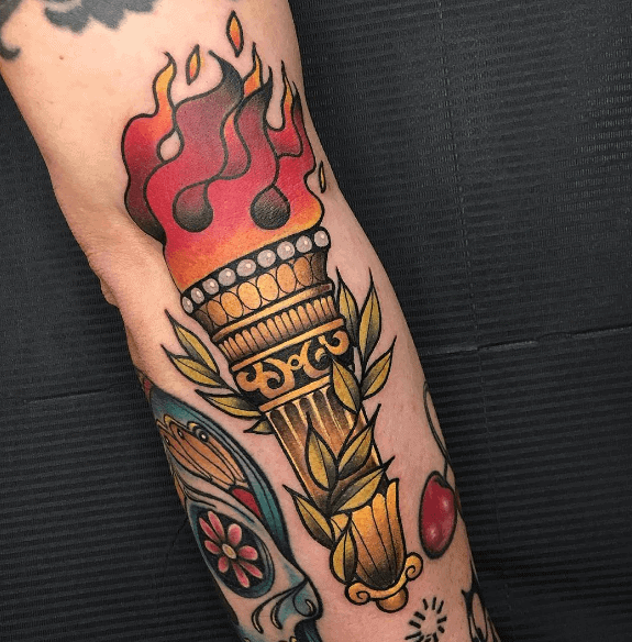 Traditional torch tattoo with glowing red flames, golden ornate handle, and olive branches wrapping around the torch.