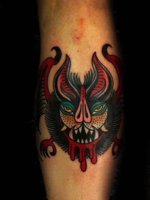 Fierce traditional bat tattoo with bold red, yellow, and black colors, sharp fangs, and dripping blood detail.