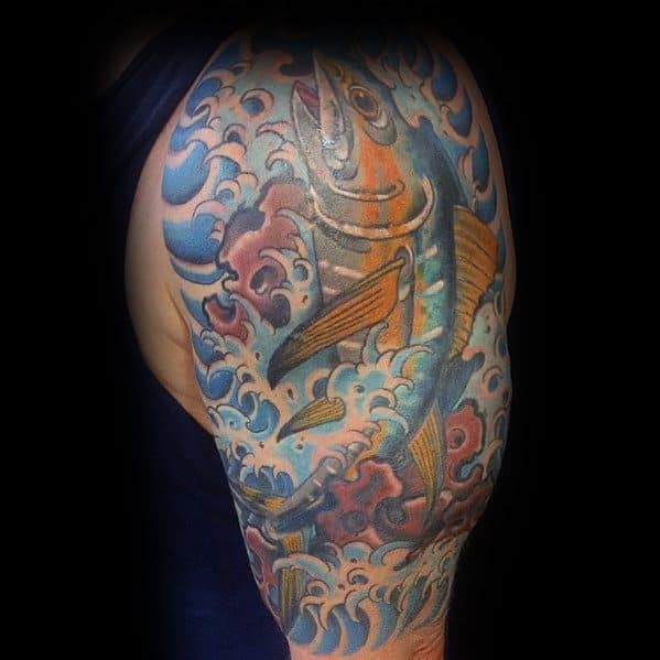 Colorful tuna fish sleeve tattoo with crashing waves, featuring intricate details and vibrant blue and gold tones for a bold oceanic design.