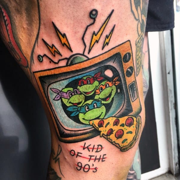 Colorful tattoo of a retro TV displaying cartoon turtles, with lightning bolts above, a slice of pizza extending from the screen, and "Kid of the 90’s" below.