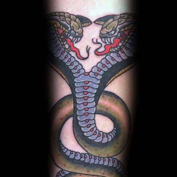 Bold two-headed cobra tattoo with striking red, black, and green tones, featuring detailed scales and fangs for a fierce and powerful look.