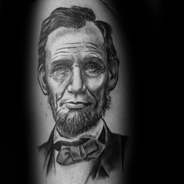 Black and gray tattoo of Abraham Lincoln in a bow tie and suit