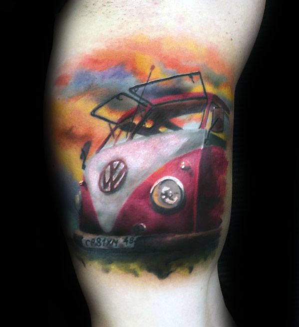 Colorful tattoo of a red and white Volkswagen van with open windows, set against a vivid sunset sky on the upper arm.