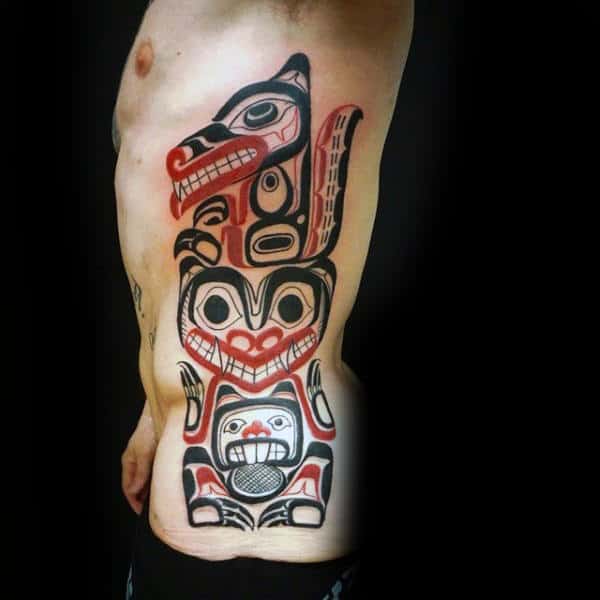 Haida Totem Pole Mens Red And Black Ink Rib Cage Side Tattoos