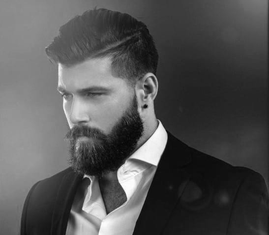 Man with a side-parted haircut and full beard