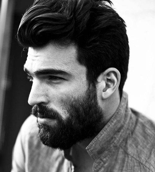 Man with voluminous, styled hair and a full beard