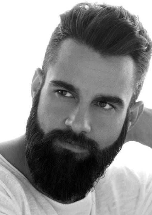 Man with a neatly styled haircut and full beard