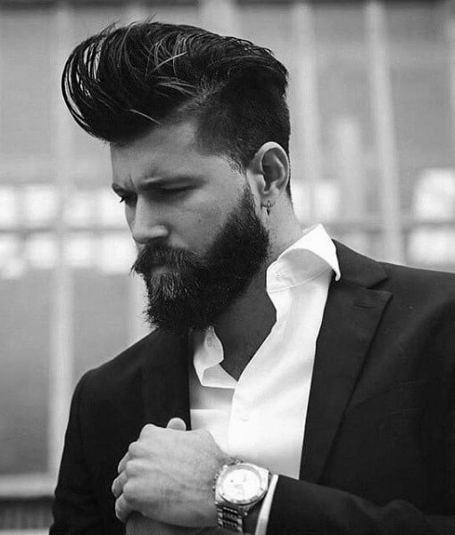 Man with voluminous, styled hair and a full beard