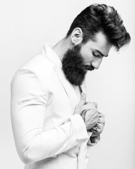 Man with voluminous, styled hair and a full beard
